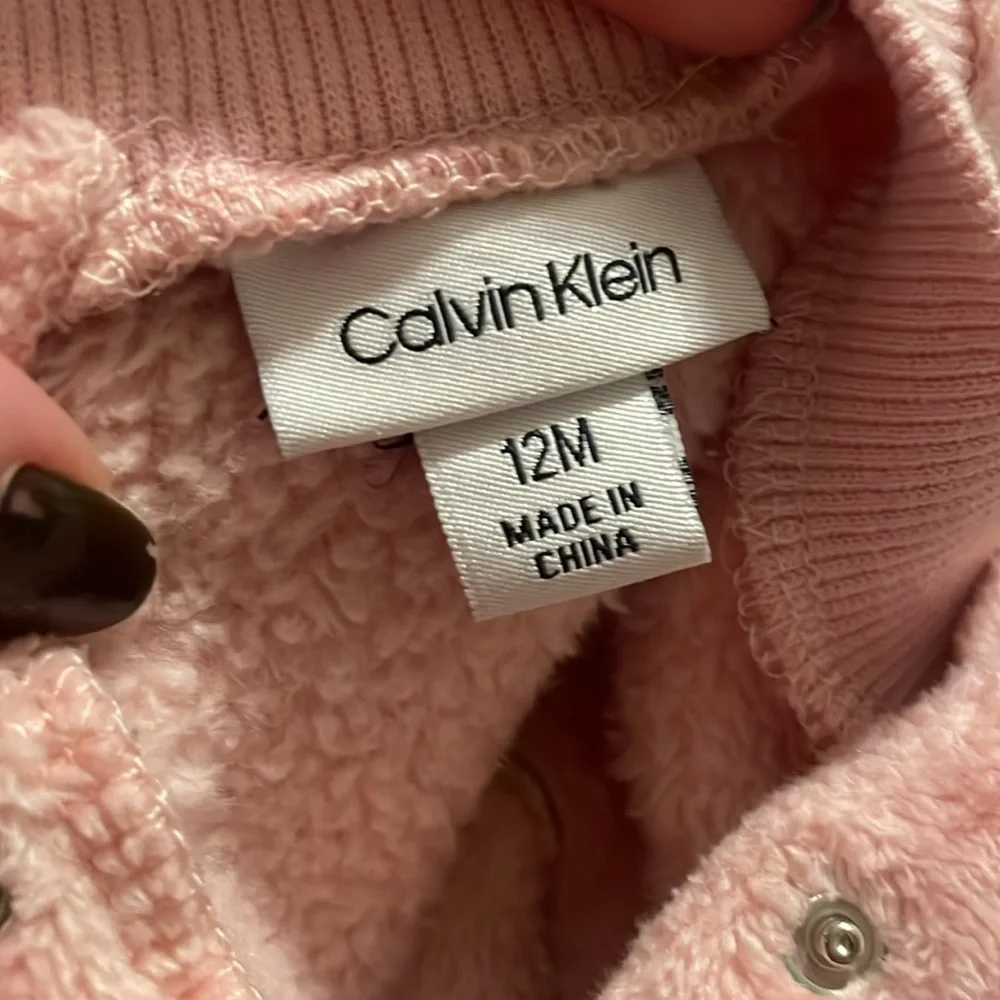 Calvin Klein size 12 months. Soft pink‎ two snap buttons behind neck. GUC.